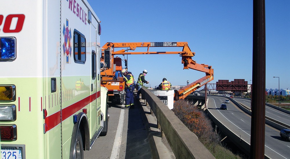 Performing bridge inspections with the use of an articulating boom lift